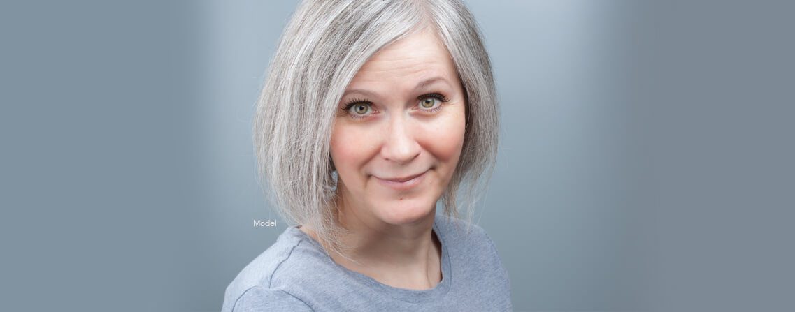 headshot middle aged female model with gray hair