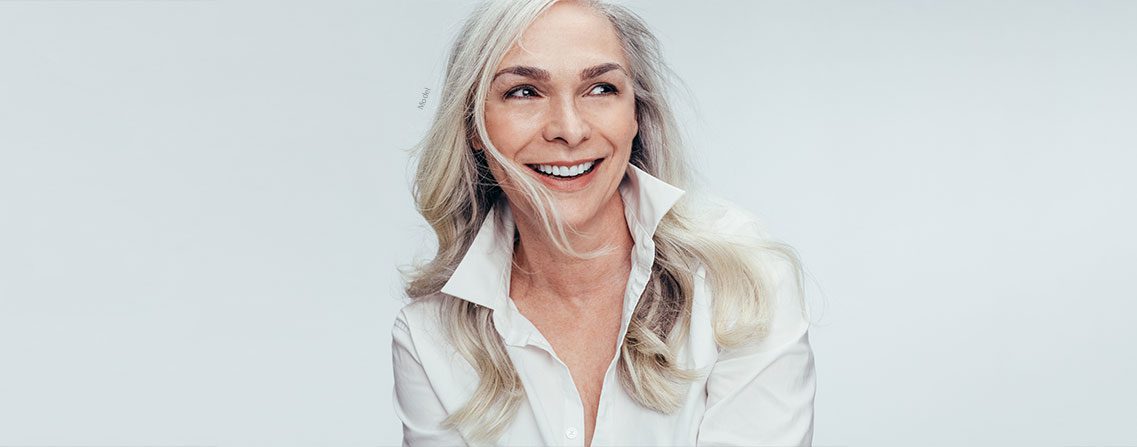 banner of middle aged woman in a white button up shirt