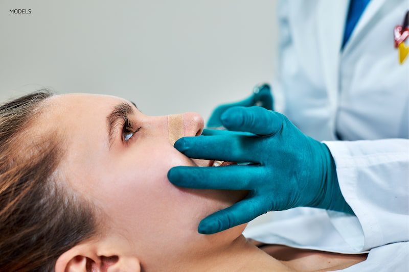 woman at the conclusion of a nasal reconstruction procedure.