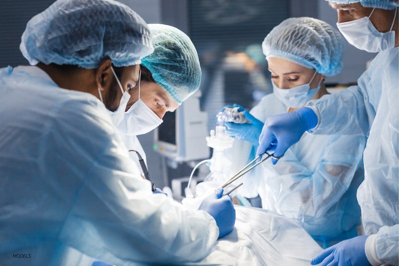 Surgical team performing surgery in operating room.