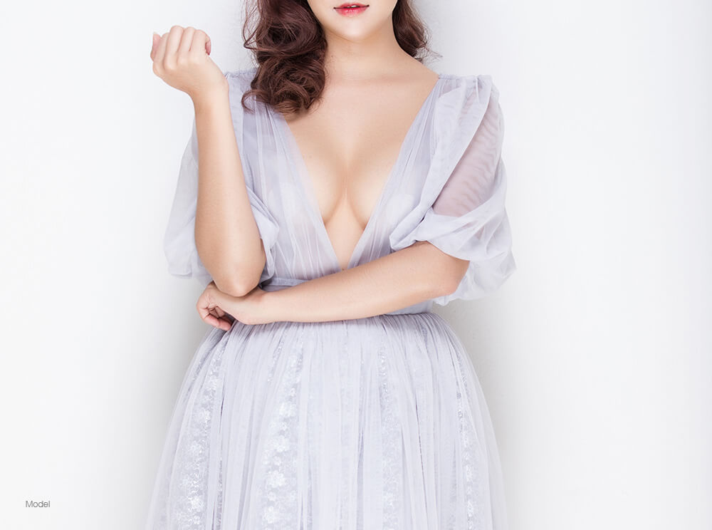 Woman in a blue dress showing cleavage 
