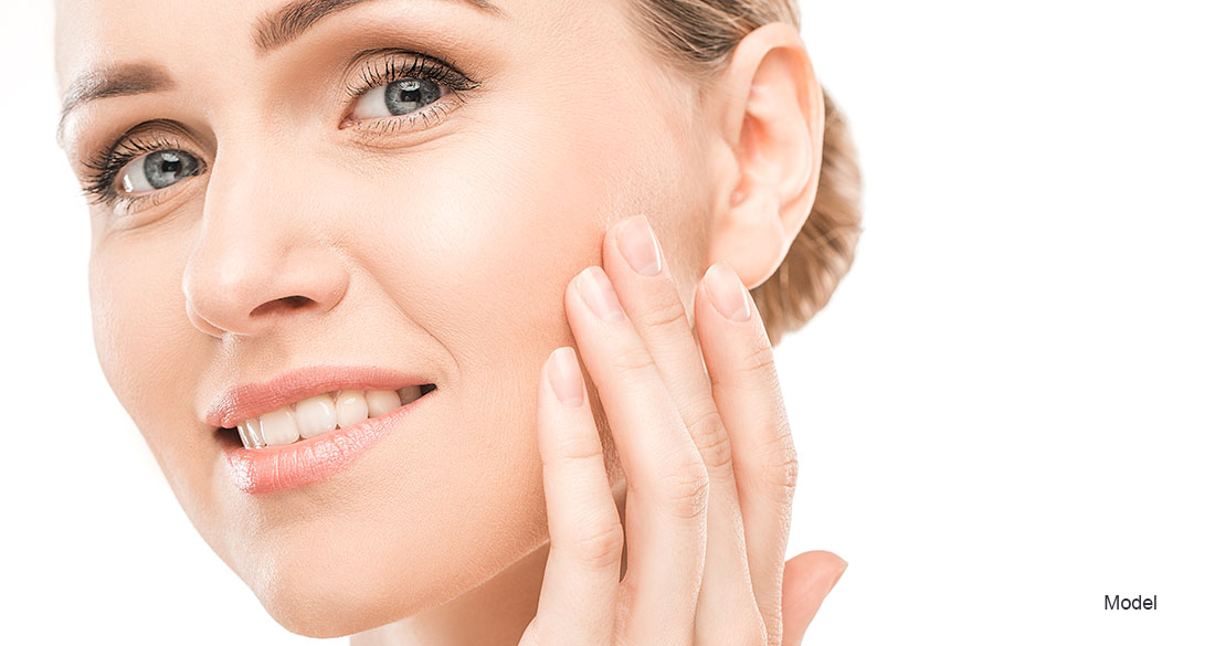 Mature woman touching her face