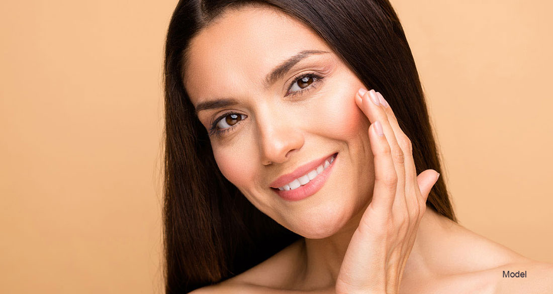 Mature woman touching her face