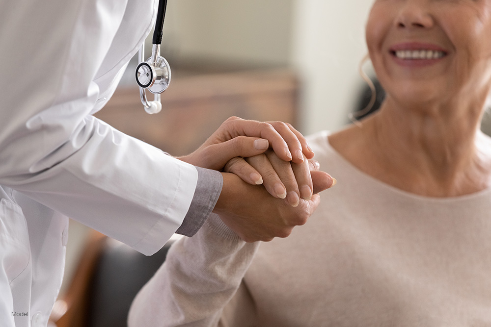 Doctor holding a patients hands in support