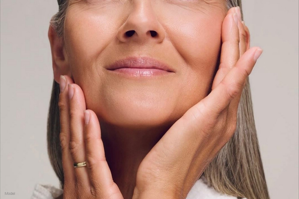 Up close of a mature woman touching her face